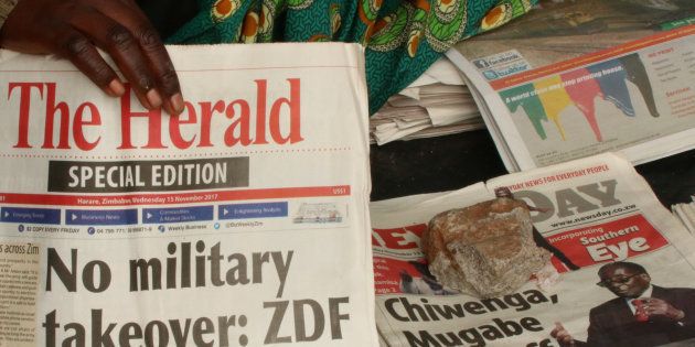 A vendor picks up a copy of a special edition of the state-owned daily newspaper The Herald in Harare, Zimbabwe November 15, 2017.