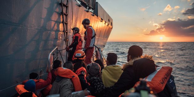 MSF and SOS Mediterannee Search and Rescue personnel from the vessel, Aquarius, intervene to rescue refugees and migrants from an over-crowded wooden boat, 28 December 2016, in the Mediterranean sea off the northern coast of Libya.