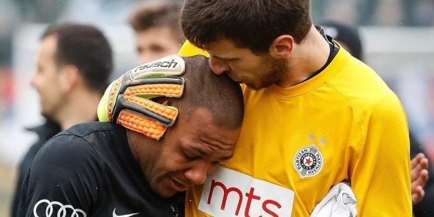 Partizan Belgrade's goalkeeper Filip Kljajic (R) hugs Brazilian midfielder Everton Luiz as he leaves the field in tears on February 19, 2017, at the end of a Serbian championship match between Partizan and Rad, after racist remarks from Rad's supporters, Serbian television B92 reported.Every time he touched the ball, 28-year-old Everton Luiz was being monkey-screamed from a group of supporters of Rad Belgrade, the source said. Shortly before the end, the match was briefly interrupted when Rad supporters also waved a banner with an insulting message against the Brazilian. / AFP / STR (Photo credit should read STR/AFP/Getty Images)