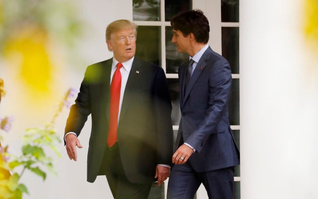 U.S. President Donald Trump walks down the White House colonnade to the Oval Office with Prime Minister Justin Trudeau.