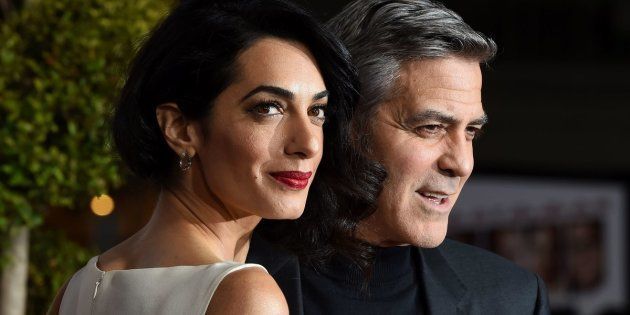 Actor George Clooney and wife Amal Clooney arrive at The Universal Premiere of Hail, Caesar! at the Regency Village Theatre, in Westwood, California, February 1, 2016 / AFP / Valerie Macon (Photo credit should read VALERIE MACON/AFP/Getty Images)