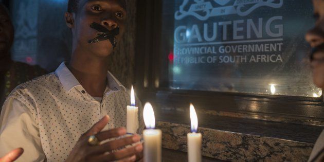 Demonstrators gathered in front of the office of the presidency of Gauteng State hold placards during a protest held over the death of psychiatry patients sent to NGOs by the Esidimeni Clinic due to the high costs of treatment.