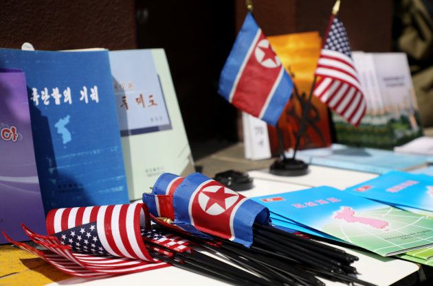 North Korean and American flags and books are displayed for sale at a stall outside the St. Regis hotel, where North Korean leader Kim Jong Un is staying in Singapore, on Monday, June 11, 2018. Presidentï¿½Donald Trumpï¿½is about to see whether his bet on North Korea will pay off: thatï¿½Kimï¿½Jong Uns desire to end his countrys economic strangulation and pariah status will prevail over the dictators fear of relinquishing his nuclear threat. Photographer: SeongJoon Cho/Bloomberg via Getty Images