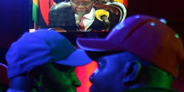 People watch as Zimbabwean President Robert Mugabe addresses the nation on television, at a bar in Harare, Zimbabwe, November 19, 2017.