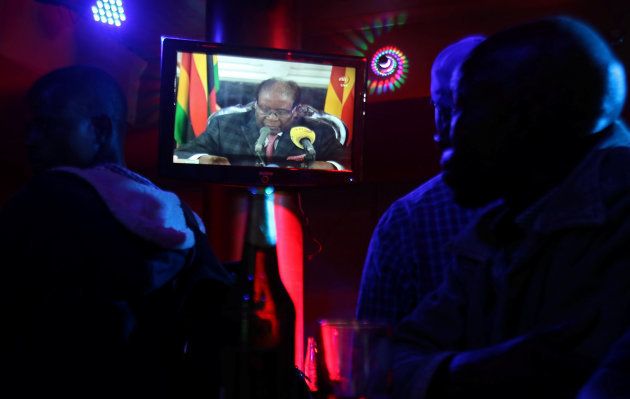 People watch as Zimbabwean President Robert Mugabe addresses the nation on television, at a bar in Harare, Zimbabwe, November 19, 2017.