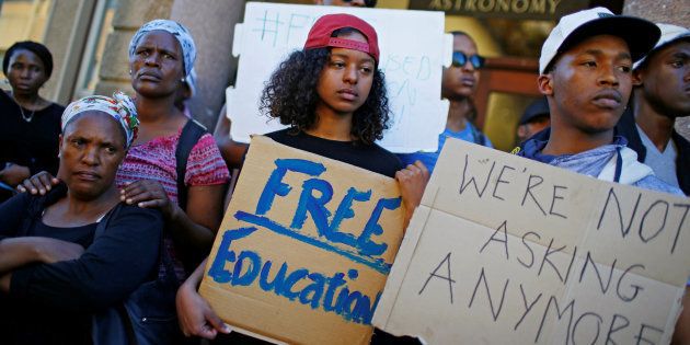 UCT students hold placards during protests demanding free tertiary education in Cape Town, , October 3 2016.