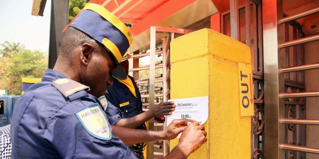 A local security staff member places a notice on the wall after anti-South African protesters attacked the MTN office in Abuja, Nigeria February 23, 2017.