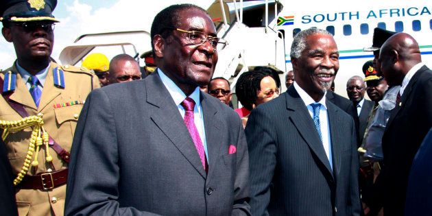Zimbabwe's President Robert Mugabe (2nd L) welcomes his South African counterpart Thabo Mbeki (2nd R) at Harare airport November 22, 2007.
