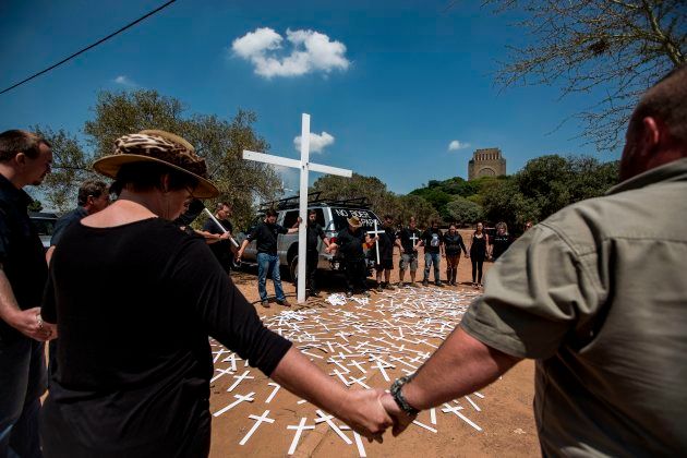 Members of the South African civic organisation, Afriforum and others in solidarity with the #Blackmonday movement pray during a demonstration against farm murders, at the Voortrekker Monument in Pretoria on October 30, 2017.