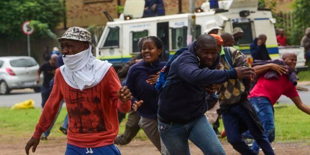 Protesters and police clash during in Pretoria on Friday during a protest by South Africans against immigrants. Police fired rubber bullets and stun grenades to control the situation.
