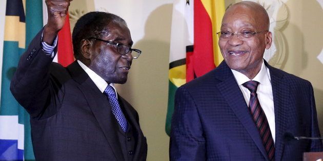 Zimbabwe's President Robert Mugabe (L) gestures as South Africa's President Jacob Zuma looks on at the end of a press briefing at the Union building in Pretoria, April 8, 2015.