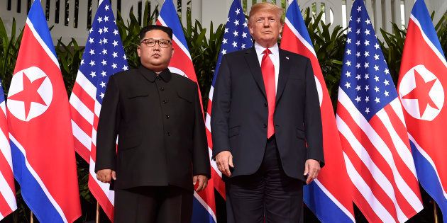 Donald Trump (R) poses with Kim Jong Un (L) at the start of their US-North Korea summit in Singapore on June 12 2018.