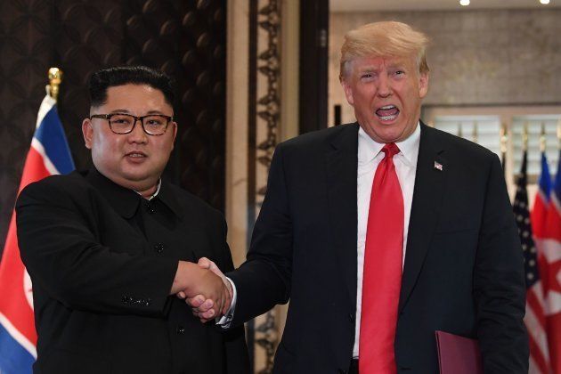 Donald Trump (R) and Kim Jong Un shake hands following a signing ceremony during their U.S.-North Korea summit. June 12 2018.