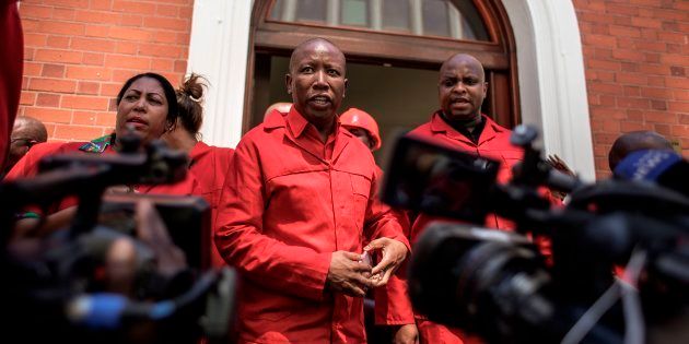 South African opposition party Economic Freedom Fighters (EFF) leader Julius Malema (C) talks to the press after staging a walk out during the election by the Members of Parliament of the new South African President on February 15, 2018 in Cape Town.