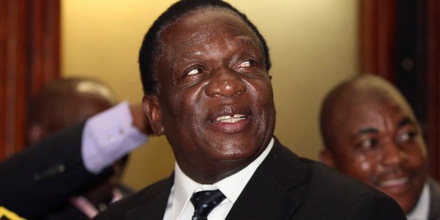 Emmerson Mnangagwa smiles at the headquarters of President Robert Mugabe's ZANU (PF) in Harare, December 10, 2014.