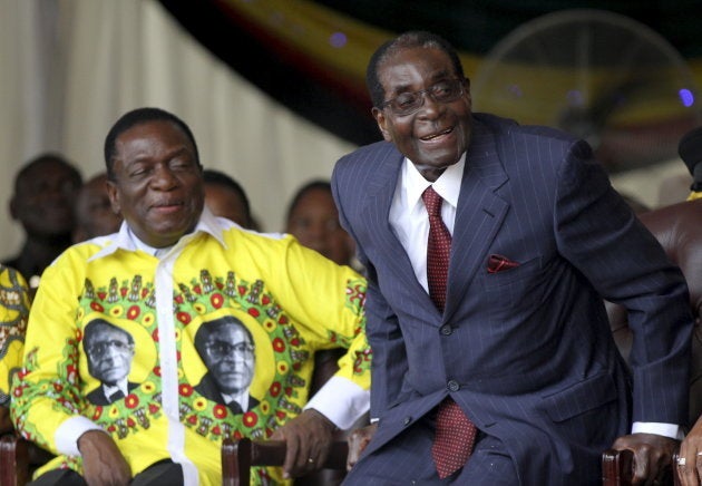 Zimbabwe's President Robert Mugabe (R) shares a joke with his vice-President Emmerson Mnangagwa during Mugabe's birthday celebrations at Great Zimbabwe in Masvingo, February 27, 2016.