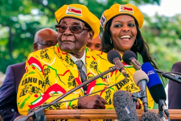 Robert Mugabe (L) addresses party members and supporters gathered at his party headquarters to show support to Grace Mugabe (R) becoming the party's next Vice President after the dismissal of Emerson Mnangagwa November 8 2017.