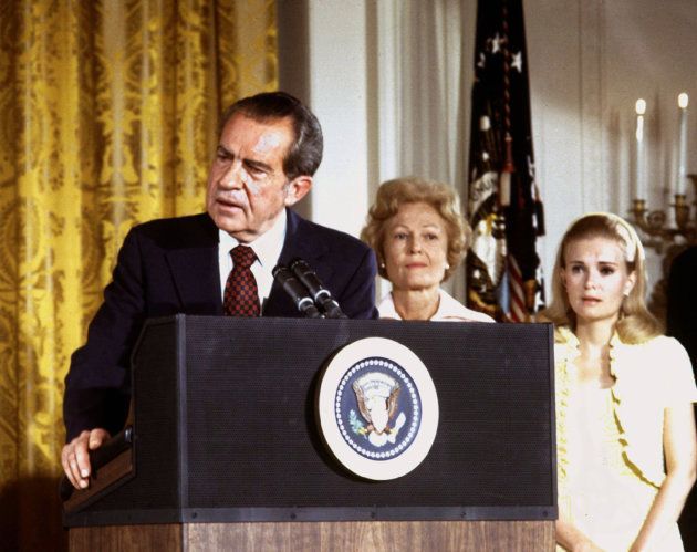 President Richard Nixon (L), listened to by First lady Pat Nixon and daughter Tricia Nixon (R), says goodbye to family and staff in the White House East Room on August 9, 1974.