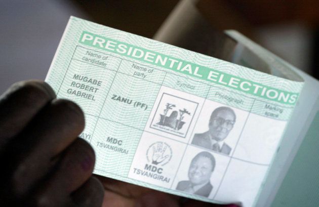 An election official holds a ballot paper showing President Robert Mugabe and opposition leader Morgan Tsvangirai in Harare, Zimbabwe June 27, 2008.
