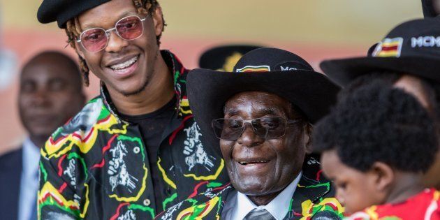 Zimbabwean President Robert Mugabe (C), with his son Robert Jr.