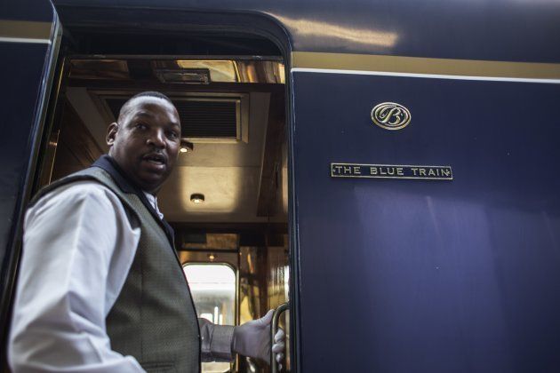 South African luxury Blue Train butler walks through coaches ahead of a press train journey on September 8, 2015.