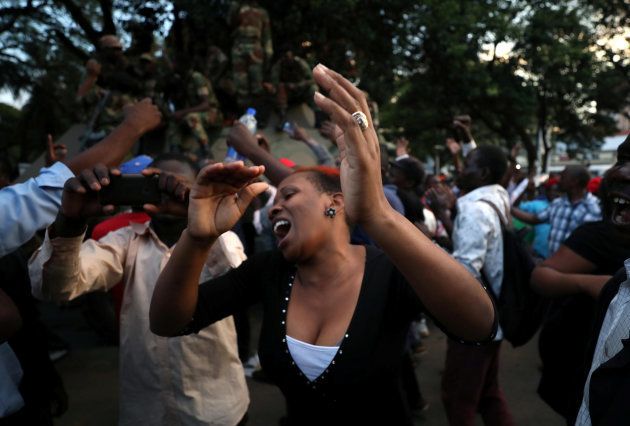 Zimbabweans celebrate after President Robert Mugabe resigns in Harare, Zimbabwe November 21, 2017.