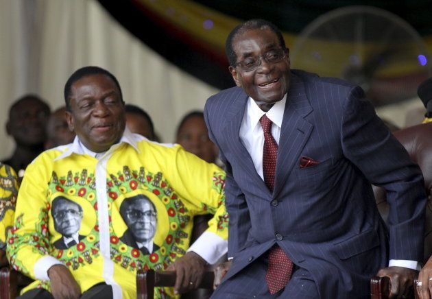 Zimbabwe's Former President Robert Mugabe (R) shares a joke with president-elect Emmerson Mnangagwa during Mugabe's birthday celebrations at Great Zimbabwe in Masvingo, February 27, 2016.