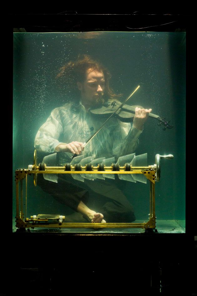Robert Karlsson plays a violin specifically crafted for underwater use.