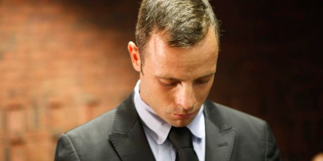 Oscar Pistorius stands in the dock during a break in court proceedings at the Pretoria Magistrates court, February 20, 2013.