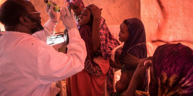 A doctor checks on a young girl at a government-run clinic in Karin Sarmayo in Somalia.