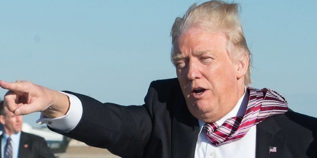 US President Donald Trump waves to wellwishers after stepping off Air Force One at Andrews Air Force Base in Maryland upon his return from Philadelphia on January 26, 2017.Donald Trump made his maiden voyage outside the Washington area as US president Thursday, meeting with lawmakers to map out their 2017 policy strategy and smooth emerging differences between the White House and congressional Republicans. / AFP / NICHOLAS KAMM (Photo credit should read NICHOLAS KAMM/AFP/Getty Images)