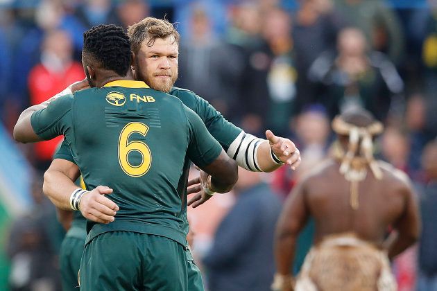 South Africa flanker and captain Siya Kolisi (L) hugs South Africa's hooker Akker van der Merwe at the beginning of the second test match South Africa vs England at the Free State Stadium in Bloemfontein, on June 16, 2018.