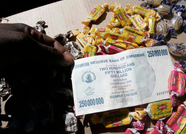 A sweet vendor holds a Zimbabwe $250-million note in the capital Harare May 10, 2008.