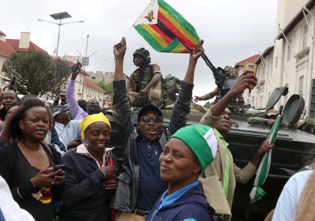 Protesters calling for Zimbabwean President Robert Mugabe to step down cheer in front of a military vehicle in Harare, Zimbabwe, November 18, 2017.