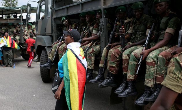 A local poses in front of the military truck after the swearing in of Zimbabwe's new president Emmerson Mnangagwa in Harare, Zimbabwe, November 24, 2017.