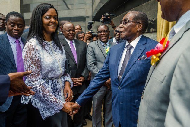 Zimbabwean President Robert Mugabe (R) is congratulated by First Lady Grace Mugabe after he unveiled a plaque at the country's main international airport in Harare, Zimbabwe, renamed after him on November 9, 2017.