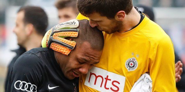 Partizan Belgrade's goalkeeper Filip Kljajic (R) hugs Brazilian midfielder Everton Luiz.
