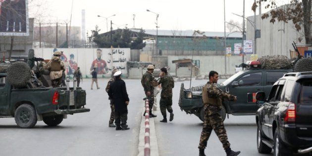 Members of the Afghan security forces stand at the site of a blast and gunfire in Kabul, Afghanistan, on March 8, 2017.