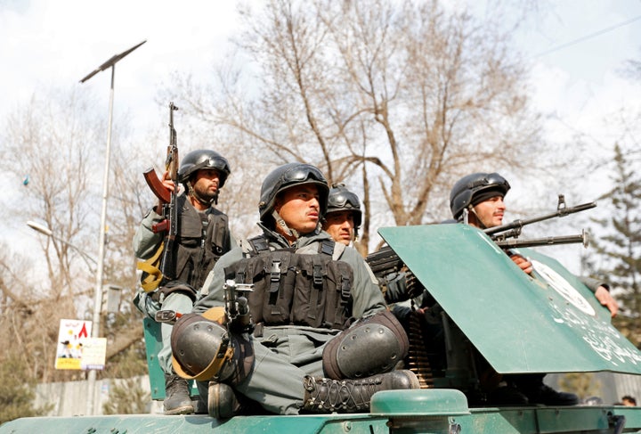 Afghan policeman arrive at the site of a blast and gunfire in Kabul, Afghanistan March 8, 2017. REUTERS/Mohammad Ismail