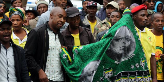 Supporters of South Africa's President Jacob Zuma gather outside the headquarters of the ruling African National Congress (ANC) party, in Johannesburg, South Africa April 7, 2017. REUTERS/Marius Bosch