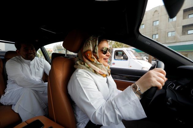 Samira al-Ghamdi, a practicing psychologist, drives to work, with her son Abdulmalik, 26, sitting behind, in Jeddah, Saudi Arabia June 24, 2018. REUTERS/Zohra Bensemra