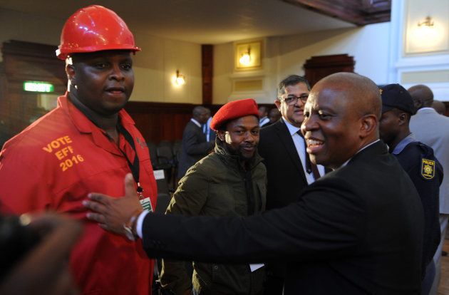 EFFs Floyd Shivambu and Mbuyiseni Ndlozi share a word with Herman Mashaba during an inaugural council meeting on August 22, 2016 in Johannesburg, South Africa. During the council meeting DAs Herman Mashaba received 144 votes, while ANCs Parks Tau received 125 votes.