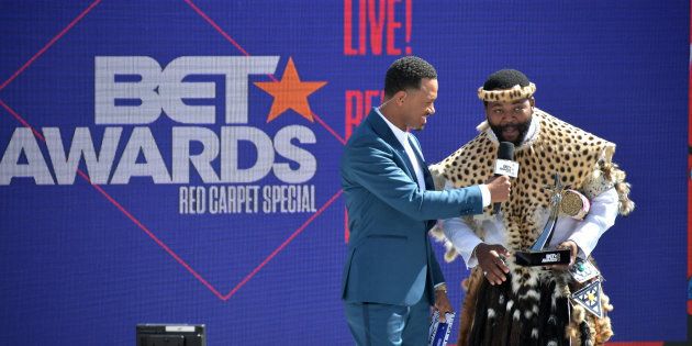 Host Terrence J presents the International Viewer's Choice award for Best New Act to Sjava onstage at Live! Red! Ready! Pre-Show on Sunday.