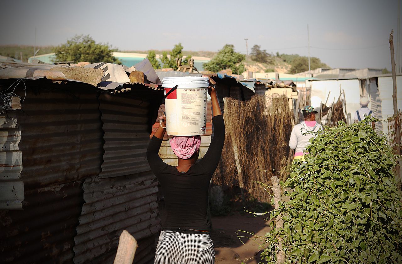 A resident carries water in Good Hope