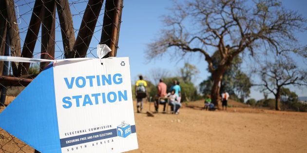 Locals are seen outside a polling station during tense local munincipal elections in Vuwani, South Africa's northern Limpopo province, August 3, 2016.