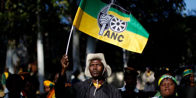 An ANC supporter holds the party's flag.