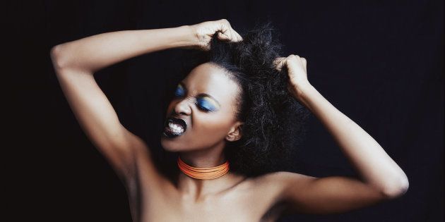 A beautiufl young african woman posing in the studio isolated on white