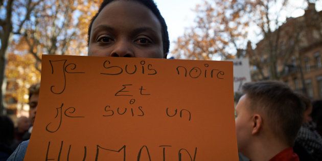 A woman shows a placard reading 'I'm black and I'm a human being'. A protest took place in Toulouse, France, on November 26 against slavery and slave trade, following CNN's exposé of a human-trafficking syndicate. Demonstrators want to raise awareness about the slave trade, migration and refugees' reception in the EU.
