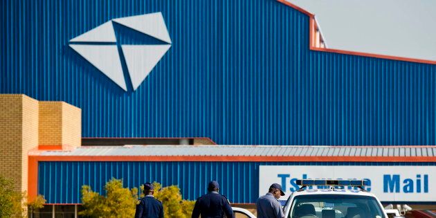 Police officers outside the Tshwane Mail Centre on May 30, 2012 in Pretoria, South Africa where post office workers have been striking against an unresolved labour broking issue. Rubber bullets as well as live ammunition has been used to disperse strikers.