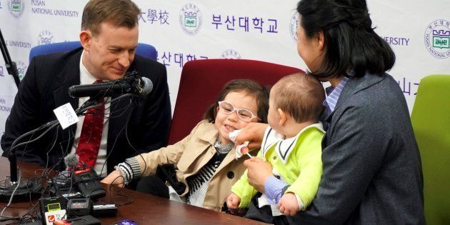 Robert Kelly (L), an expert on East Asian affairs and a professor at South Korea's Pusan National University, his wife Kim Jung-A (R), daughter Marion (2nd L) and toddler son James (2nd R) attend a press conference at the university in Busan on March 15, 2017. The professor who became an incidental internet sensation when his family crashed a live television interview says his wife 'deserves a medal' for looking after him and his now-famous children.